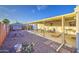 Landscaped backyard with gravel, covered patio, and a decorative brick wall at 7318 E Arbor Ave, Mesa, AZ 85208