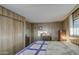 Primary bedroom featuring wood-paneled walls, closet, and natural light at 7318 E Arbor Ave, Mesa, AZ 85208