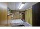 Bedroom featuring wood-paneled walls and natural light at 7318 E Arbor Ave, Mesa, AZ 85208