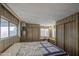 Spacious bedroom featuring wood-paneled walls and built-in vanity at 7318 E Arbor Ave, Mesa, AZ 85208