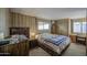Bright bedroom featuring wood-paneled walls and two windows for natural light at 7318 E Arbor Ave, Mesa, AZ 85208