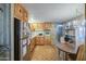 Cozy eat-in kitchen featuring wood cabinets and stainless steel refrigerator at 7318 E Arbor Ave, Mesa, AZ 85208