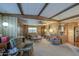 Inviting living room with carpet floors, multiple seating options, and neutral tones at 7318 E Arbor Ave, Mesa, AZ 85208