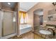 Bathroom featuring a soaking tub, shower, dual sink vanity and granite counters at 7778 N 51St Ln, Glendale, AZ 85301