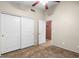 Spacious bedroom featuring tile flooring, closet with sliding doors and ceiling fan at 7778 N 51St Ln, Glendale, AZ 85301