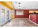 Dining area with double doors to backyard, tile flooring, and lots of natural light at 7778 N 51St Ln, Glendale, AZ 85301