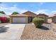 Charming single-story home showcasing a two-car garage and easy-care desert landscaping at 7778 N 51St Ln, Glendale, AZ 85301
