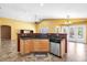 Kitchen view with breakfast bar, stainless steel appliances, and bright natural lighting at 7778 N 51St Ln, Glendale, AZ 85301