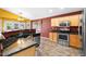 Updated kitchen with granite countertops, stainless steel appliances, and light wood cabinets at 7778 N 51St Ln, Glendale, AZ 85301