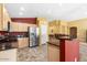 Kitchen with stainless appliances, tile floors, breakfast bar and light wood cabinets at 7778 N 51St Ln, Glendale, AZ 85301