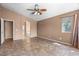 Open living room view shows tile flooring and arched doorway to other rooms in the home at 7778 N 51St Ln, Glendale, AZ 85301