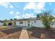 Spacious backyard with rock landscaping, patio and white exterior of the home at 843 N Evergreen St, Chandler, AZ 85225