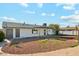 Spacious backyard with rock landscaping, patio and white exterior of the home at 843 N Evergreen St, Chandler, AZ 85225
