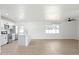 Modern kitchen features an island, stainless steel appliances, and an open layout with luxury vinyl plank flooring at 843 N Evergreen St, Chandler, AZ 85225