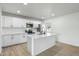 Modern kitchen features stainless steel appliances, white cabinetry, and a center island with a breakfast bar at 843 N Evergreen St, Chandler, AZ 85225