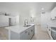 Modern kitchen boasting a center island with quartz countertop, stainless steel appliances and neutral flooring at 843 N Evergreen St, Chandler, AZ 85225