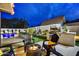 Outdoor entertaining space with a fire pit, built-in grill, swimming pool, and lush landscaping at 87 W Windsor Ave, Phoenix, AZ 85003