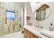Bright bathroom features marble walk-in shower, gold fixtures, and a large, oval mirror at 87 W Windsor Ave, Phoenix, AZ 85003