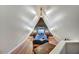 Attic bedroom with sloped ceiling, hardwood floors, and custom bedside tables at 87 W Windsor Ave, Phoenix, AZ 85003