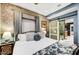 Comfortable bedroom with unique wallpaper, sliding barn door to bath, and a wrought iron frame at 87 W Windsor Ave, Phoenix, AZ 85003