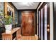 Elegant entryway featuring a paneled wood door, striking wallpaper, and stylish decor at 87 W Windsor Ave, Phoenix, AZ 85003