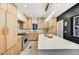 Well-lit kitchen with an expansive island, stainless steel appliances, and light wood cabinets at 87 W Windsor Ave, Phoenix, AZ 85003