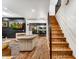 Open-concept living room with hardwood floors, a staircase, and an adjacent dining area at 87 W Windsor Ave, Phoenix, AZ 85003