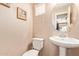 Stylish powder room features a pedestal sink, round mirror, and neutral decor at 900 S 94Th St # 1166, Chandler, AZ 85224