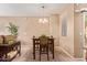 Inviting dining area featuring a stylish table with four chairs, a modern chandelier, and neutral decor at 900 S 94Th St # 1166, Chandler, AZ 85224