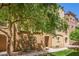Beautiful exterior view showcasing a well-maintained multi-story townhouse with a landscaped lawn and desert trees at 900 S 94Th St # 1166, Chandler, AZ 85224