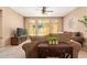 Bright living room with a large window, a plush sofa, a media console, and a ceiling fan at 900 S 94Th St # 1166, Chandler, AZ 85224
