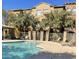 Outdoor community pool with lounge chairs and inviting turquoise water is surrounded by trees and colorful buildings at 900 S 94Th St # 1166, Chandler, AZ 85224