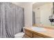 Cozy bathroom featuring a vanity with a white sink and a decorative shower curtain at 9309 E Obispo Ave, Mesa, AZ 85212