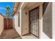 Secured front entrance with a security door and desert landscaping at 9309 E Obispo Ave, Mesa, AZ 85212