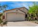A single Gathering home with a two car garage, desert landscaping, and desert plants at 9309 E Obispo Ave, Mesa, AZ 85212