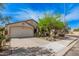 Charming single-story home with a well-maintained lawn, mature trees, and a two-car garage in a quiet neighborhood at 9309 E Obispo Ave, Mesa, AZ 85212