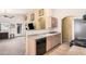 Efficient kitchen with a breakfast bar overlooking the living area, complete with modern appliances and ample counter space at 9309 E Obispo Ave, Mesa, AZ 85212
