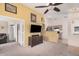 Open-concept living area with a ceiling fan and seamless transition to the kitchen, perfect for entertaining and Gathering gatherings at 9309 E Obispo Ave, Mesa, AZ 85212