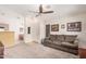 Inviting living room with carpet flooring, a ceiling fan, and neutral paint, creating a comfortable and welcoming atmosphere at 9309 E Obispo Ave, Mesa, AZ 85212