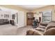 Inviting living room with a gray sofa, neutral carpet, and an open doorway to a study nook at 9309 E Obispo Ave, Mesa, AZ 85212