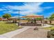 Community playground featuring shaded play structures and open grassy areas for recreation at 9309 E Obispo Ave, Mesa, AZ 85212