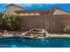 Backyard pool waterfall feature cascading over rocks, adding a tranquil touch to the landscape at 9309 E Obispo Ave, Mesa, AZ 85212