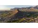 Stunning aerial view showcasing a golf course and a majestic mountain range at 9548 E Kiva Ln, Gold Canyon, AZ 85118