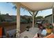 Covered patio with furniture and barbecue featuring desert landscaping, mountain views, and gravel groundcover at 9548 E Kiva Ln, Gold Canyon, AZ 85118