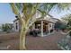 Well-maintained backyard with gravel, patio, barbecue, and covered seating area at 9548 E Kiva Ln, Gold Canyon, AZ 85118