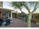 Landscaped backyard with covered patio, barbecue grill, and desert vegetation at 9548 E Kiva Ln, Gold Canyon, AZ 85118