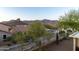Expansive backyard view with desert landscaping, a metal fence, and mountain views at 9548 E Kiva Ln, Gold Canyon, AZ 85118