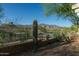 Backyard with a tall cactus, desert landscaping, metal fence, and beautiful mountain range backdrop at 9548 E Kiva Ln, Gold Canyon, AZ 85118