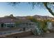 Private backyard with a metal fence, gravel landscaping, native desert plants, and stunning mountain views at 9548 E Kiva Ln, Gold Canyon, AZ 85118