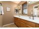 Elegant bathroom featuring dual sinks, ample countertop space, and modern lighting fixtures at 9548 E Kiva Ln, Gold Canyon, AZ 85118
